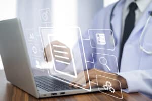A man is typing on a computer, and the image is overlayed with a holograph showing the process documentation he is using to efficiently manage files.