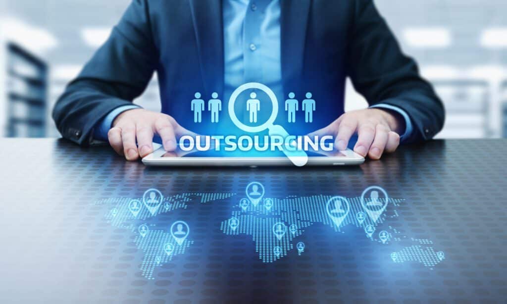 The image shows a hologram of choosing between outsourced IT services.