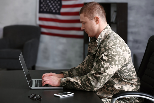 Veteran typing on computer