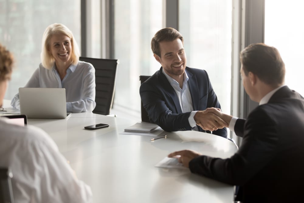 Men shaking hands for merger and acquisition