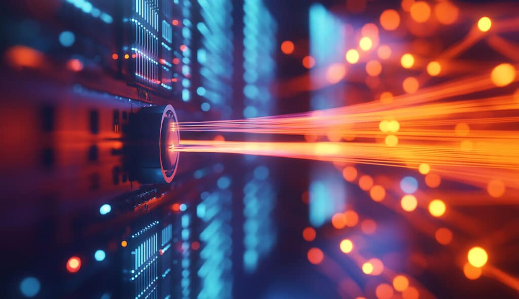 A close-up of an optical fiber cable, with bright light beams em